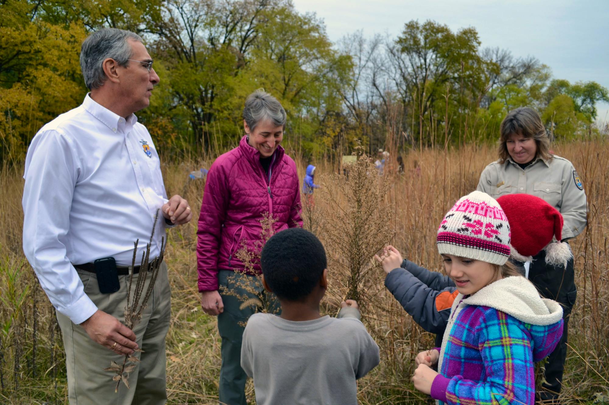 Secretary Sally Jewell and Regional Director Tom Melius help Minneapolis second graders collect native prairie seeds during her visit to Minnesota Valley National Wildlife Refuge 